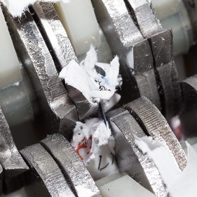 Jammed shredder scraps between paper shredder blades Jammed shredder scraps between paper shredder blades